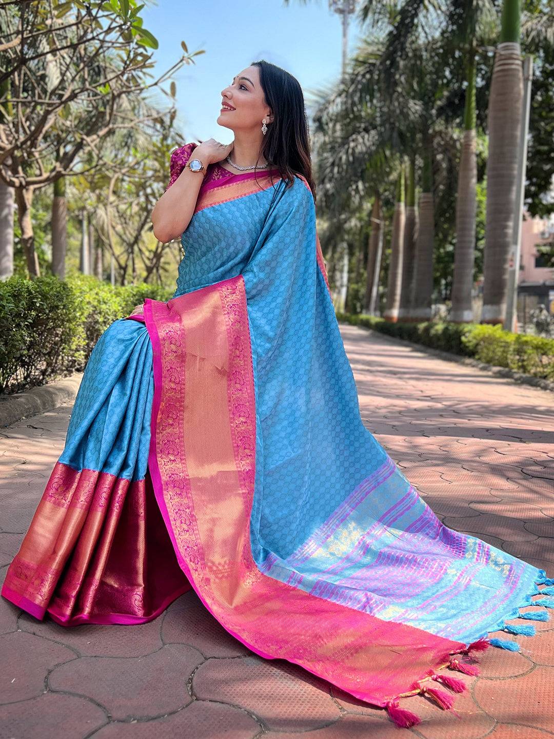 Woman posing in royal blue Kanjivaram silk saree with intricate design