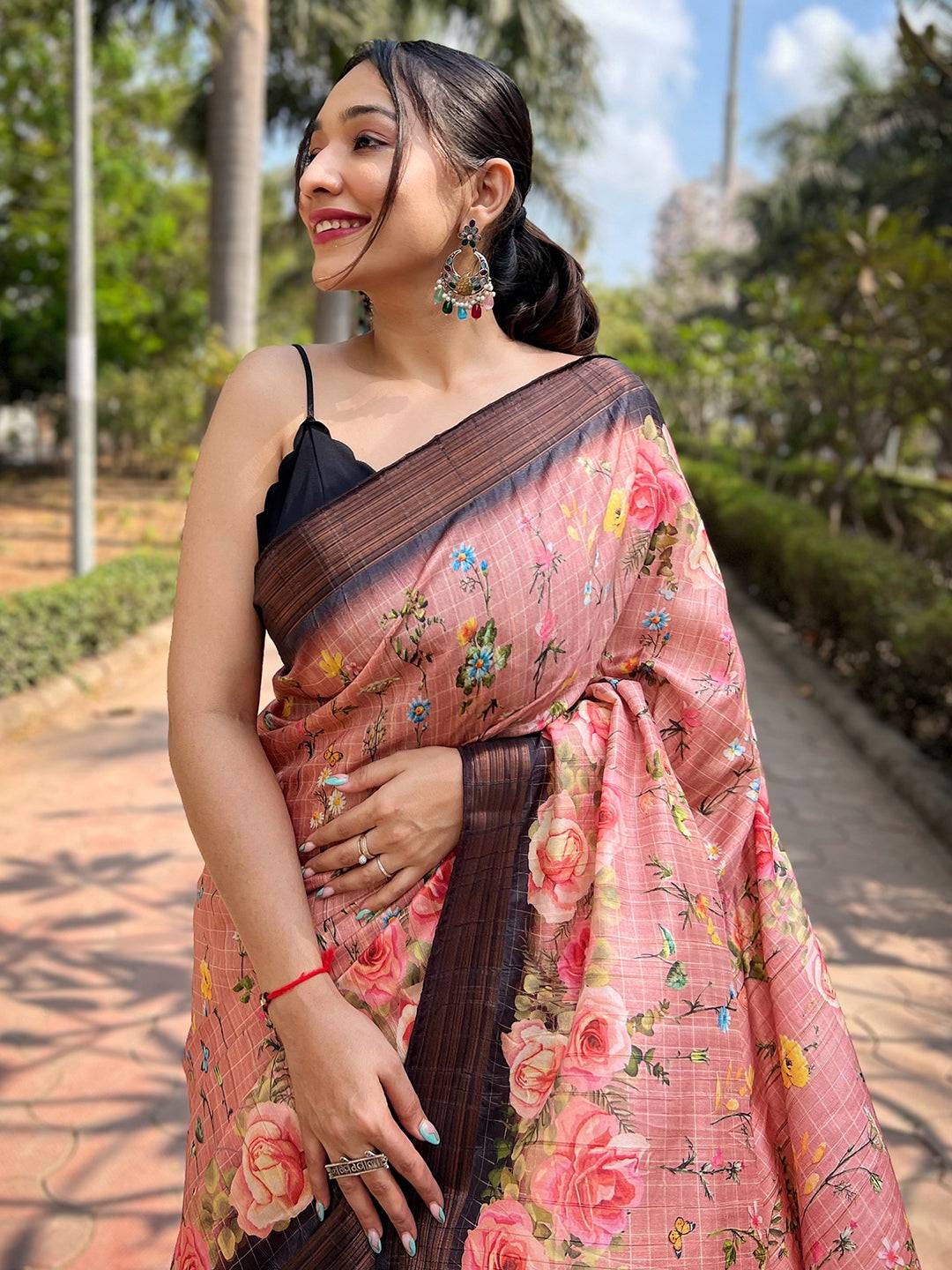 Close-up of peach silk saree with floral copper zari weaving