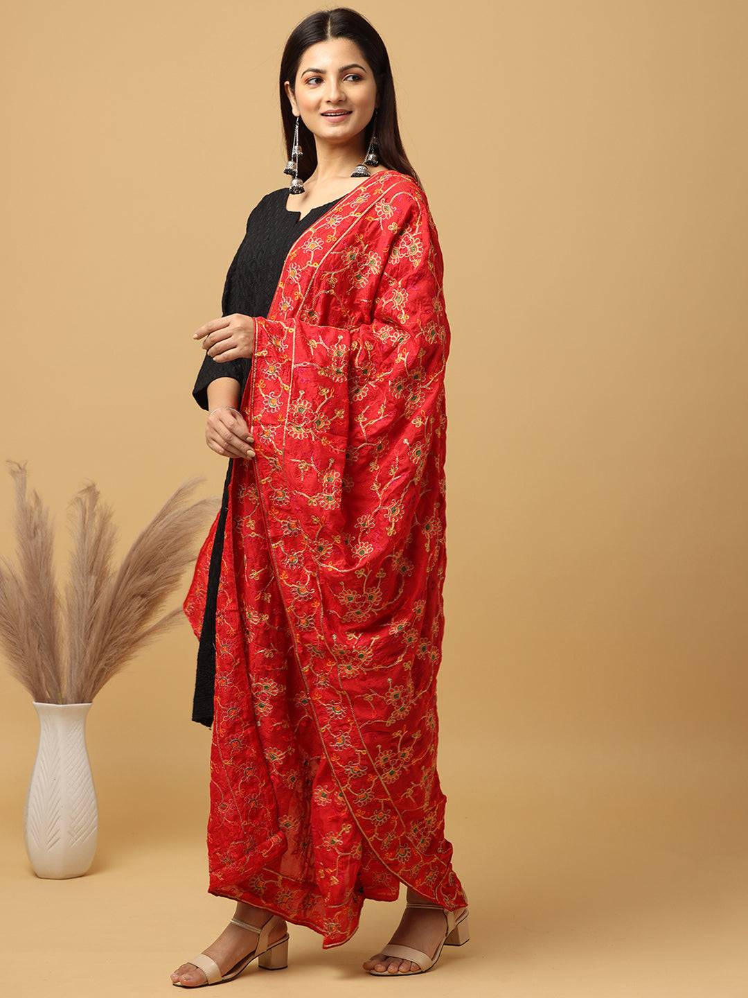 Side view of red poly chiffon pashmina dupatta with motifs.