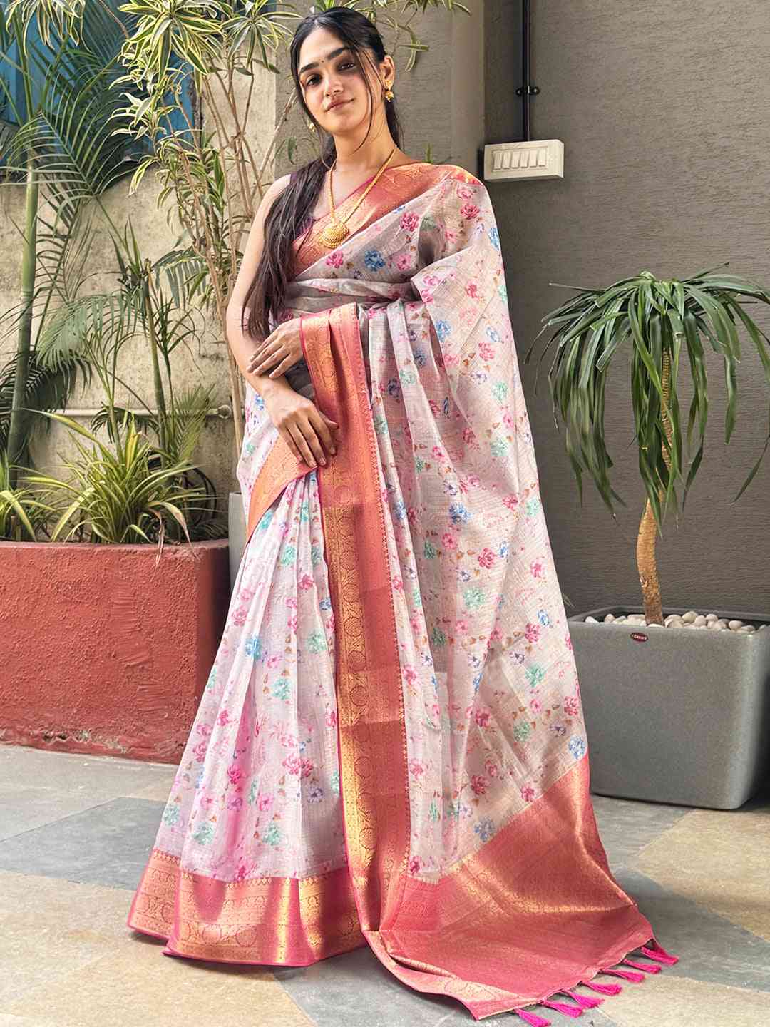 Model showcasing floral print Kota silk saree with pink border