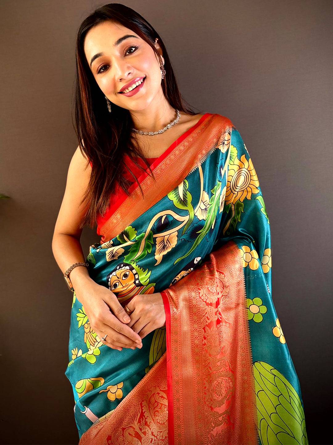 Rama soft silk saree with Pichwai Kalamkari print and gold zari border.