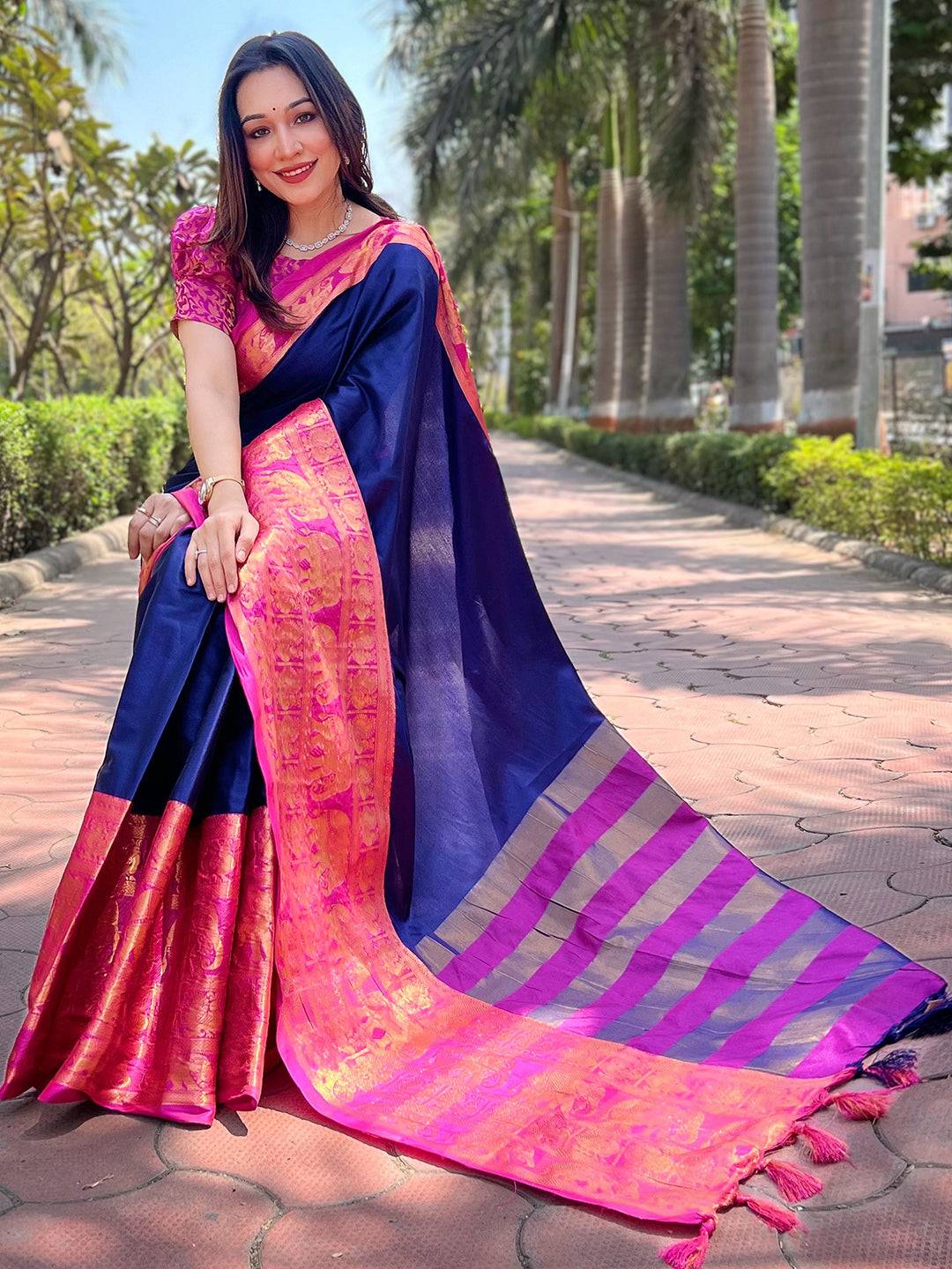 Flowing navy Kanjivaram saree with vibrant pink border details