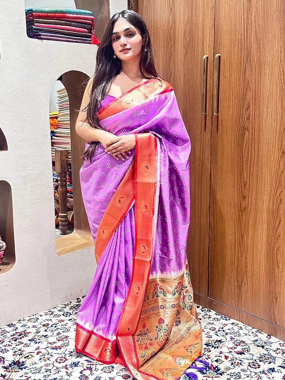Standing model in purple Bandhani saree with Paithani border