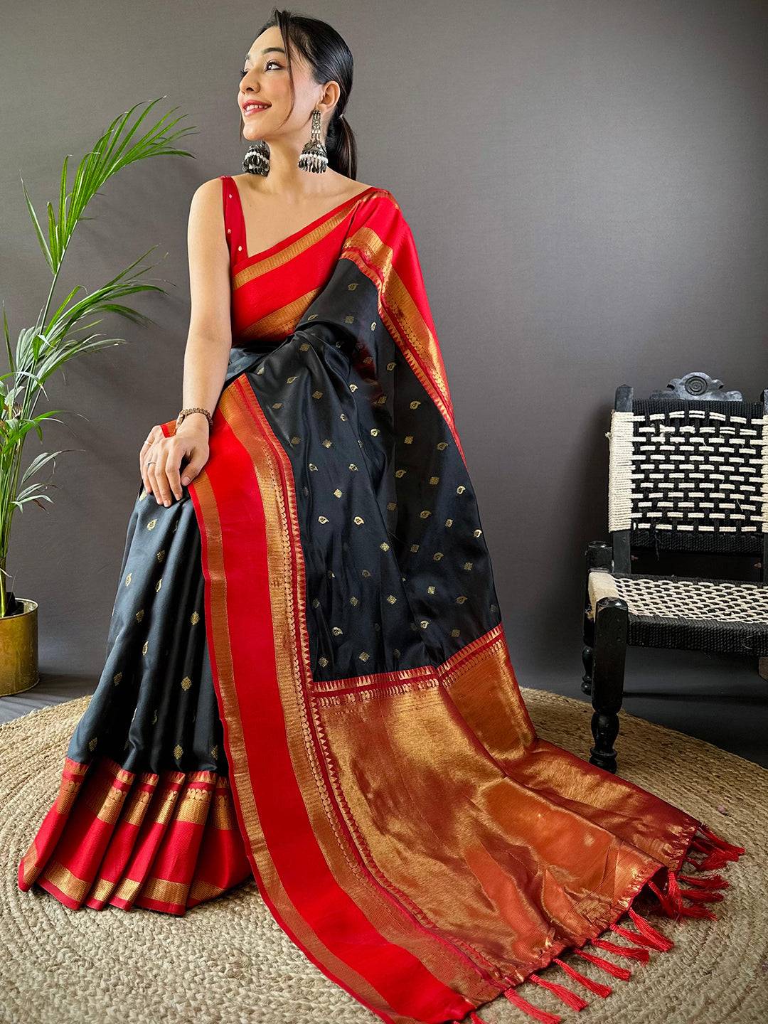 Luxurious black saree with red border and gold detailing