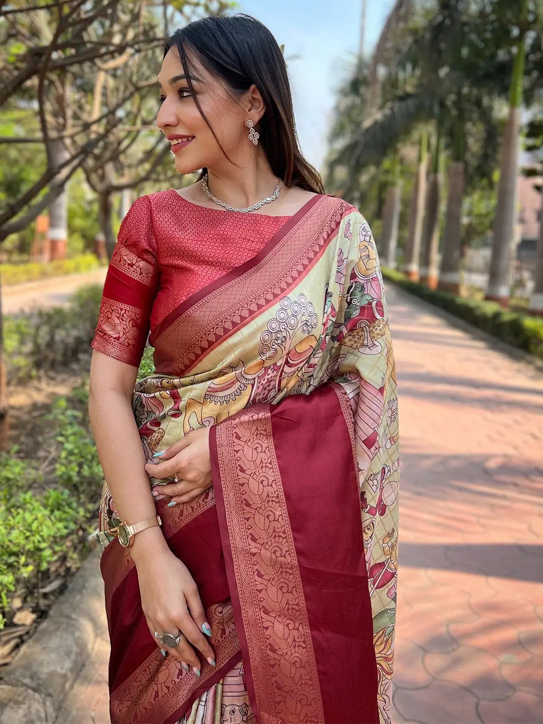Smiling woman in red Banarasi silk saree with traditional motifs