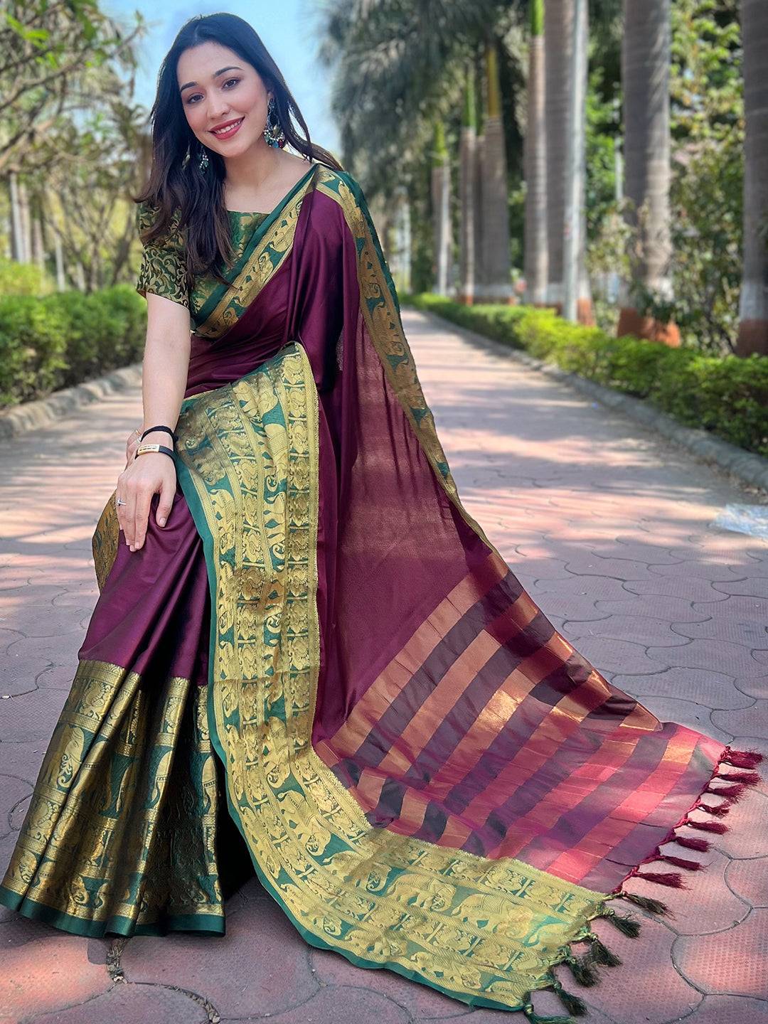 Wine silk saree with gold border, woman sitting outdoors