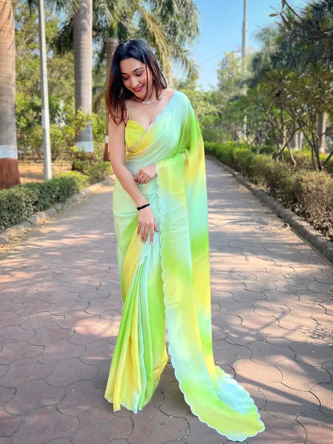 Model wearing pista satin georgette saree outdoors