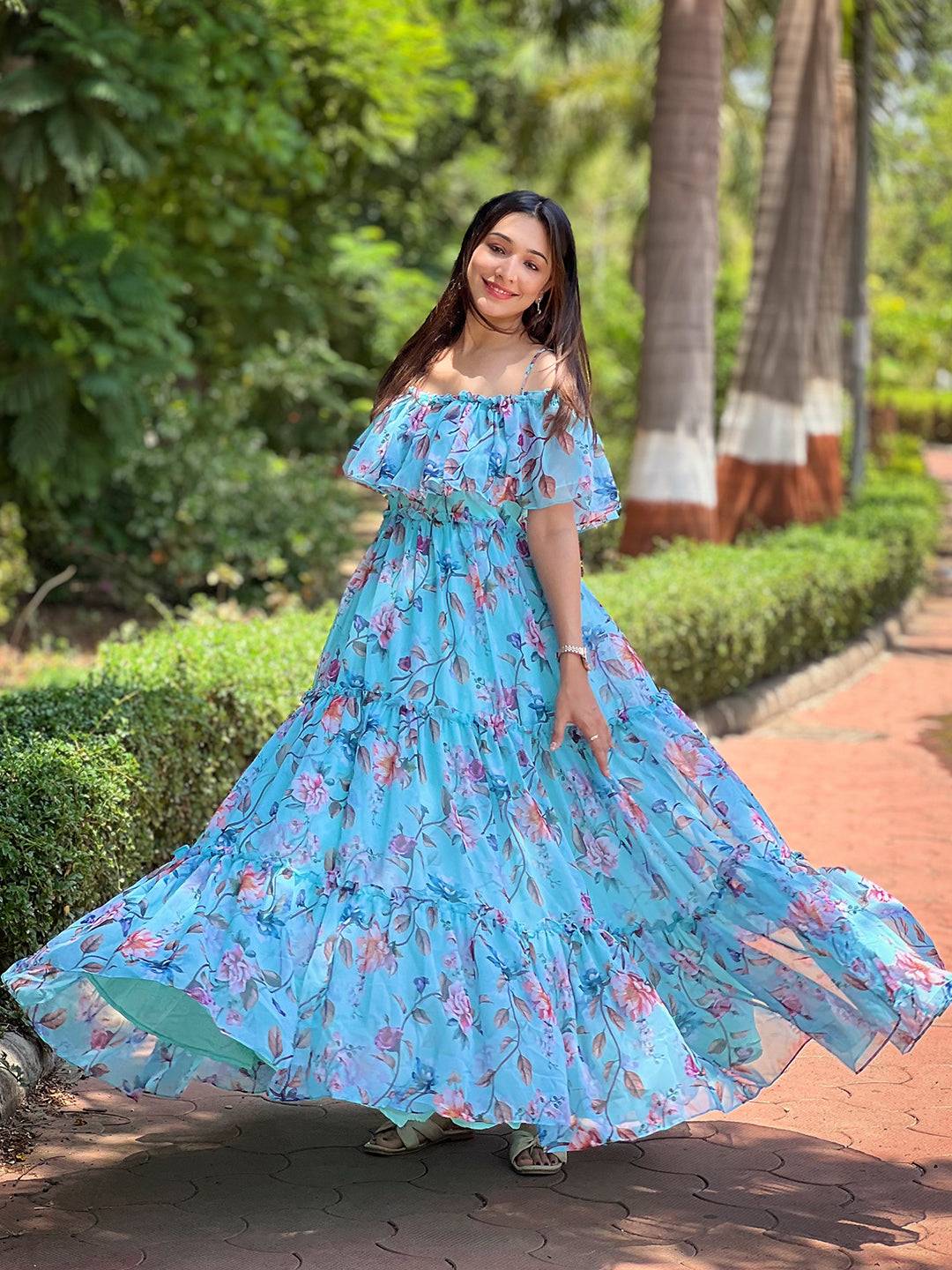 Woman twirling in blue floral maxi dress