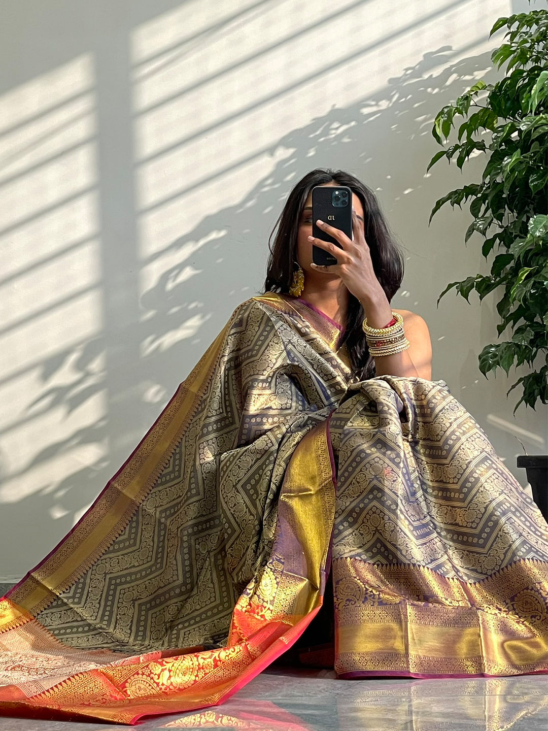 Model showcasing gold zari Kanjivaaram pattu silk saree.