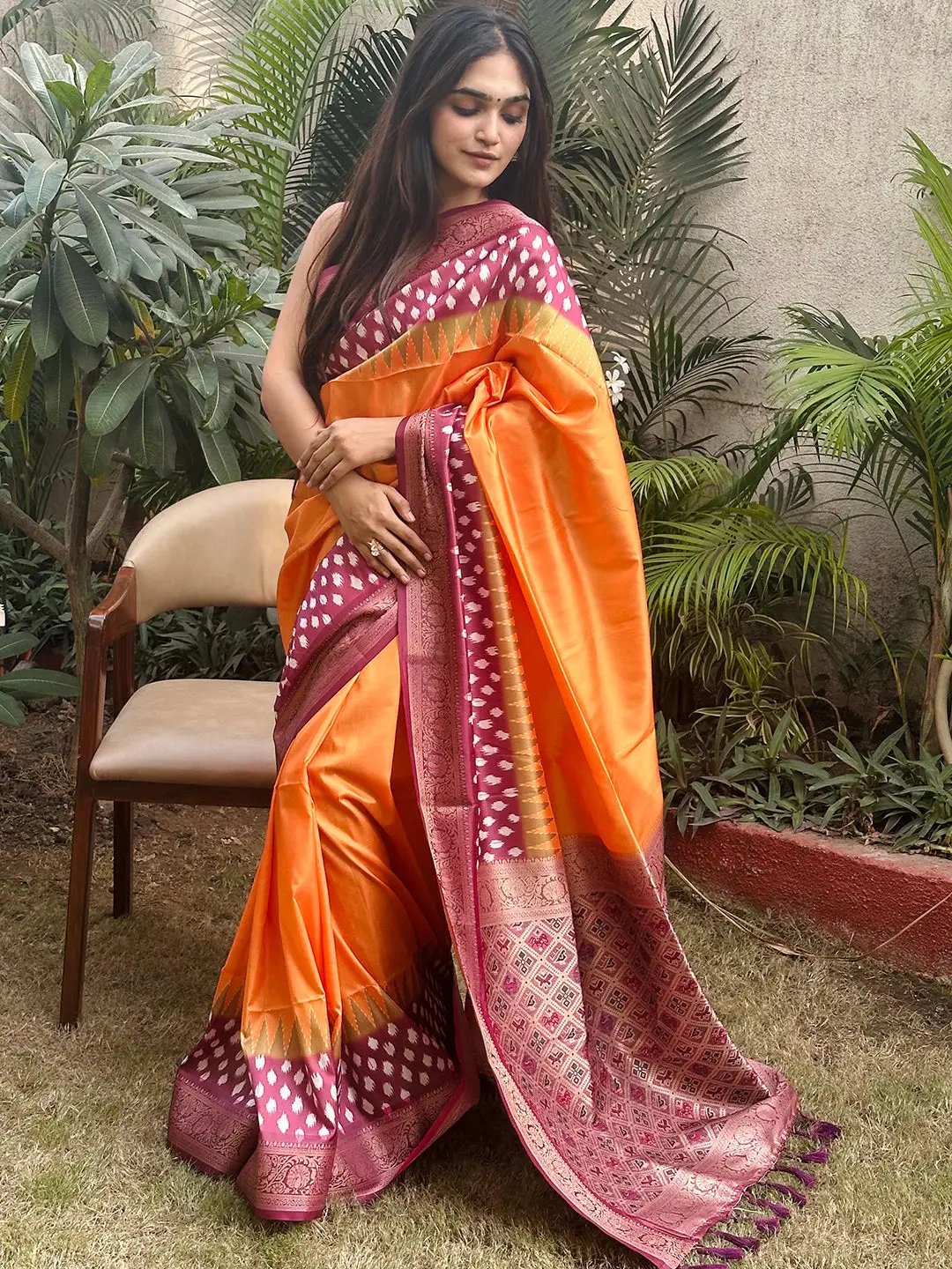 Traditional orange Banarasi saree featuring Patola pallu design
