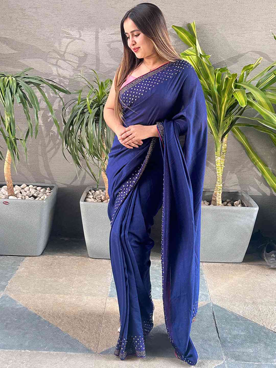 Navy Vichitra silk saree with Swarovski stones, model posing.