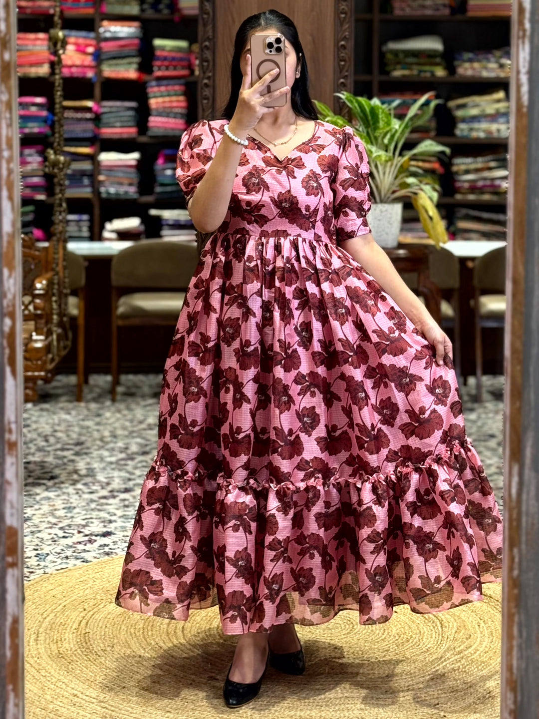 Graceful Baby Pink Floral Print Midi Dress with a feminine tiered design and puff sleeves. A must-have fashion piece available at Vastranand.
