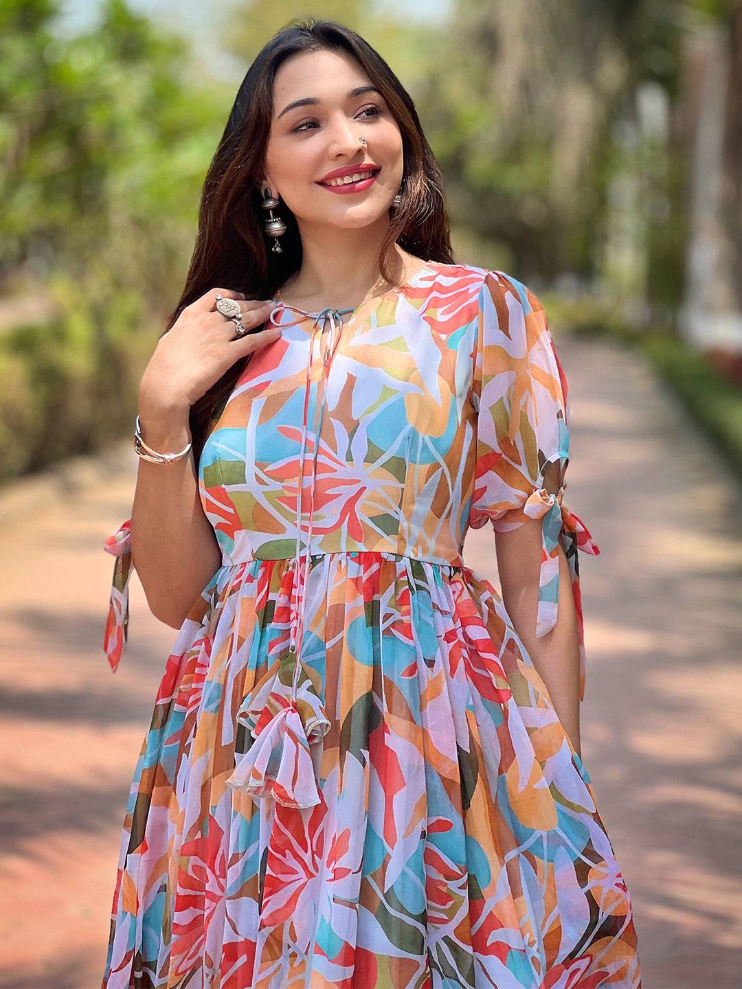 Smiling woman in vibrant abstract dress outside