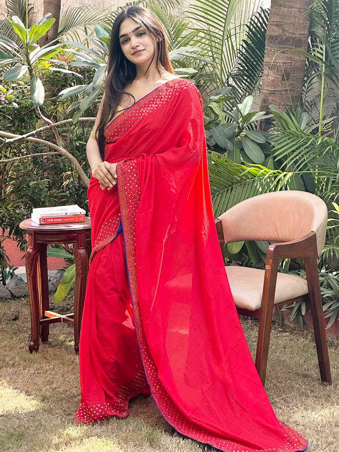 Elegant red silk saree with Swarovski embellishments outdoors
