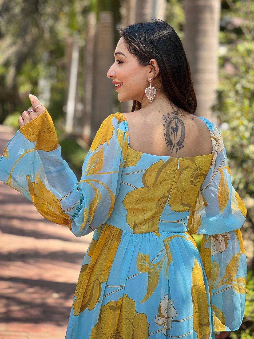 Back view of Sky Blue Floral Dress with tattoo detail
