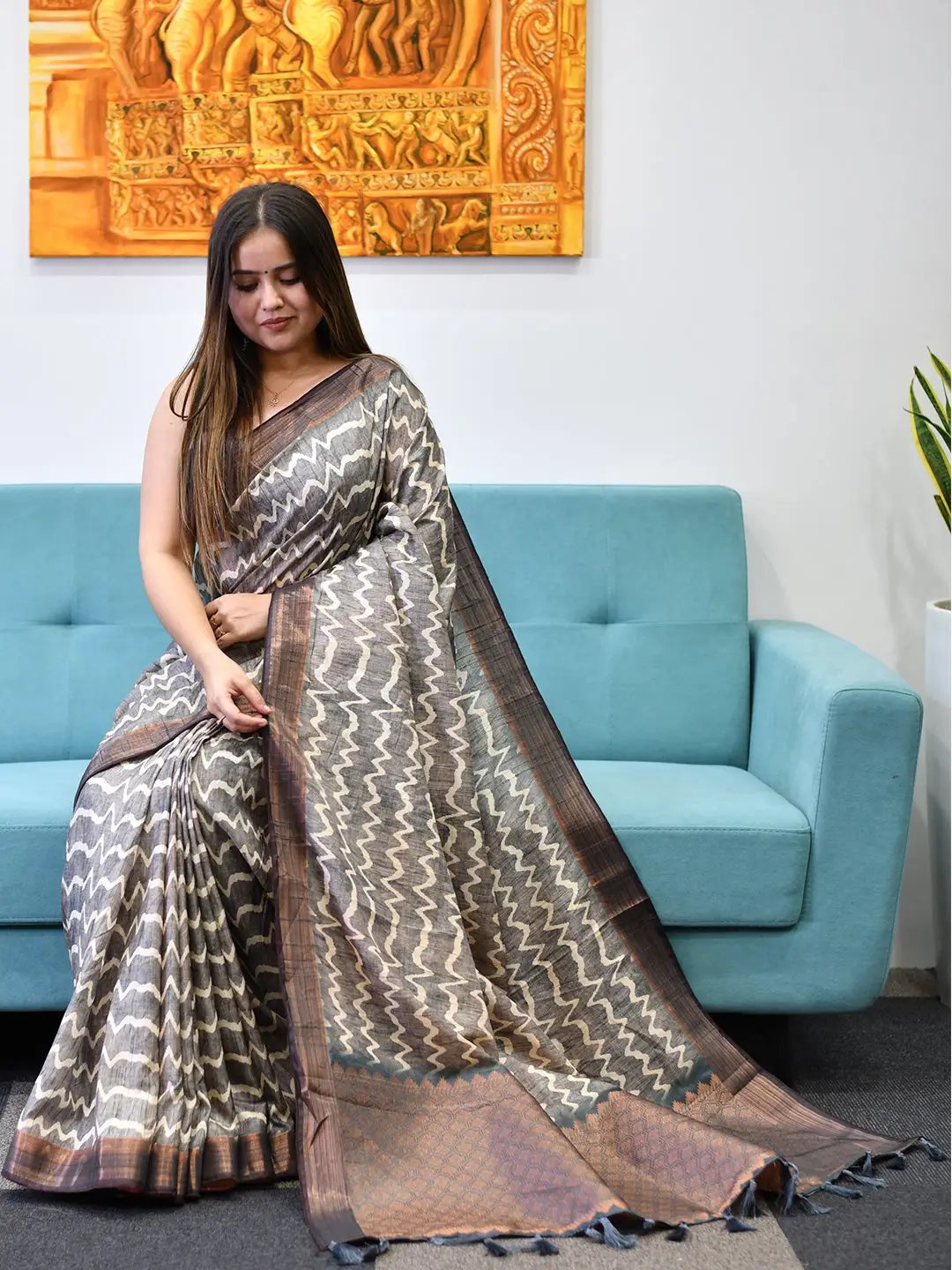Chic Tussar Ghicha Silk Saree with digital print on blue sofa