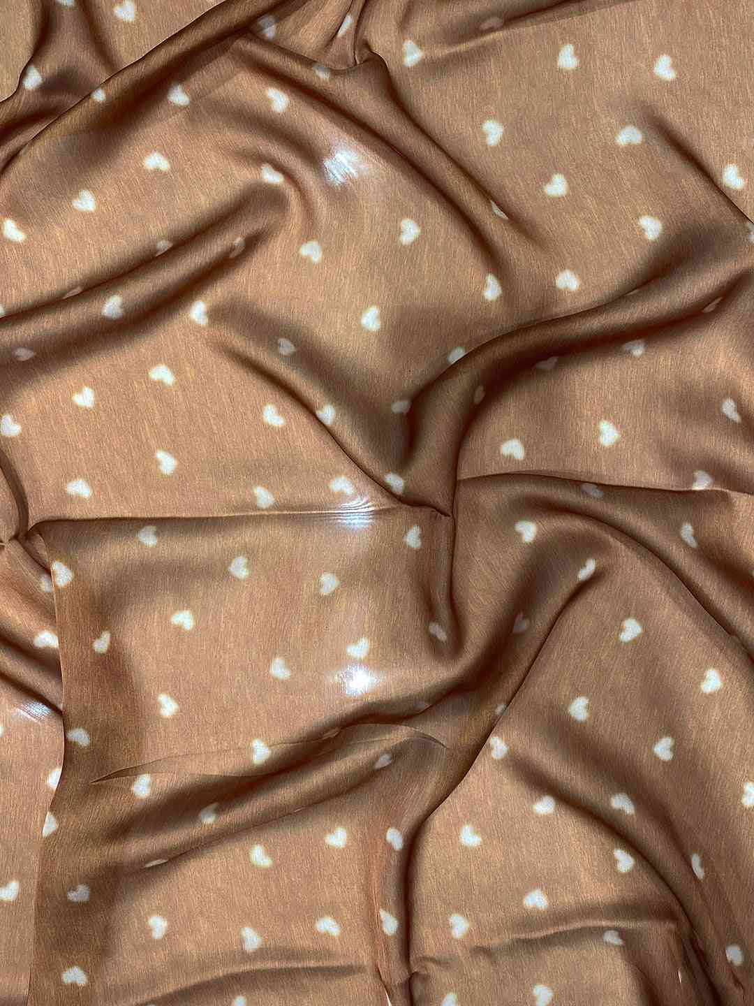 Brown fabric with small white heart patterns