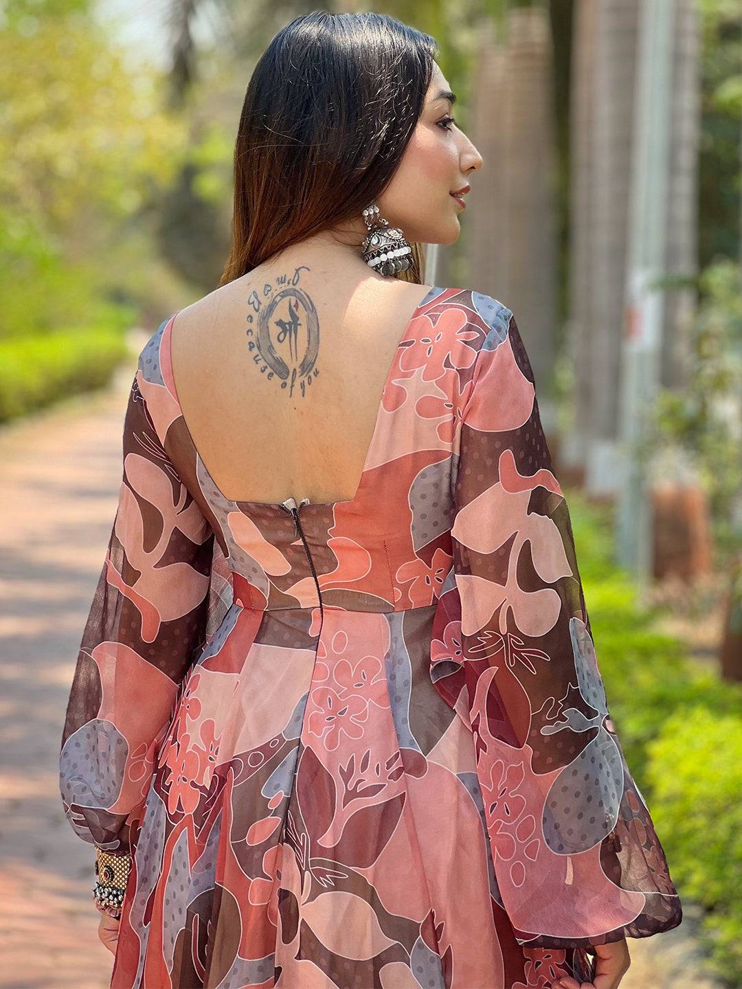 Back view of coffee brown abstract print dress with tattoo detail