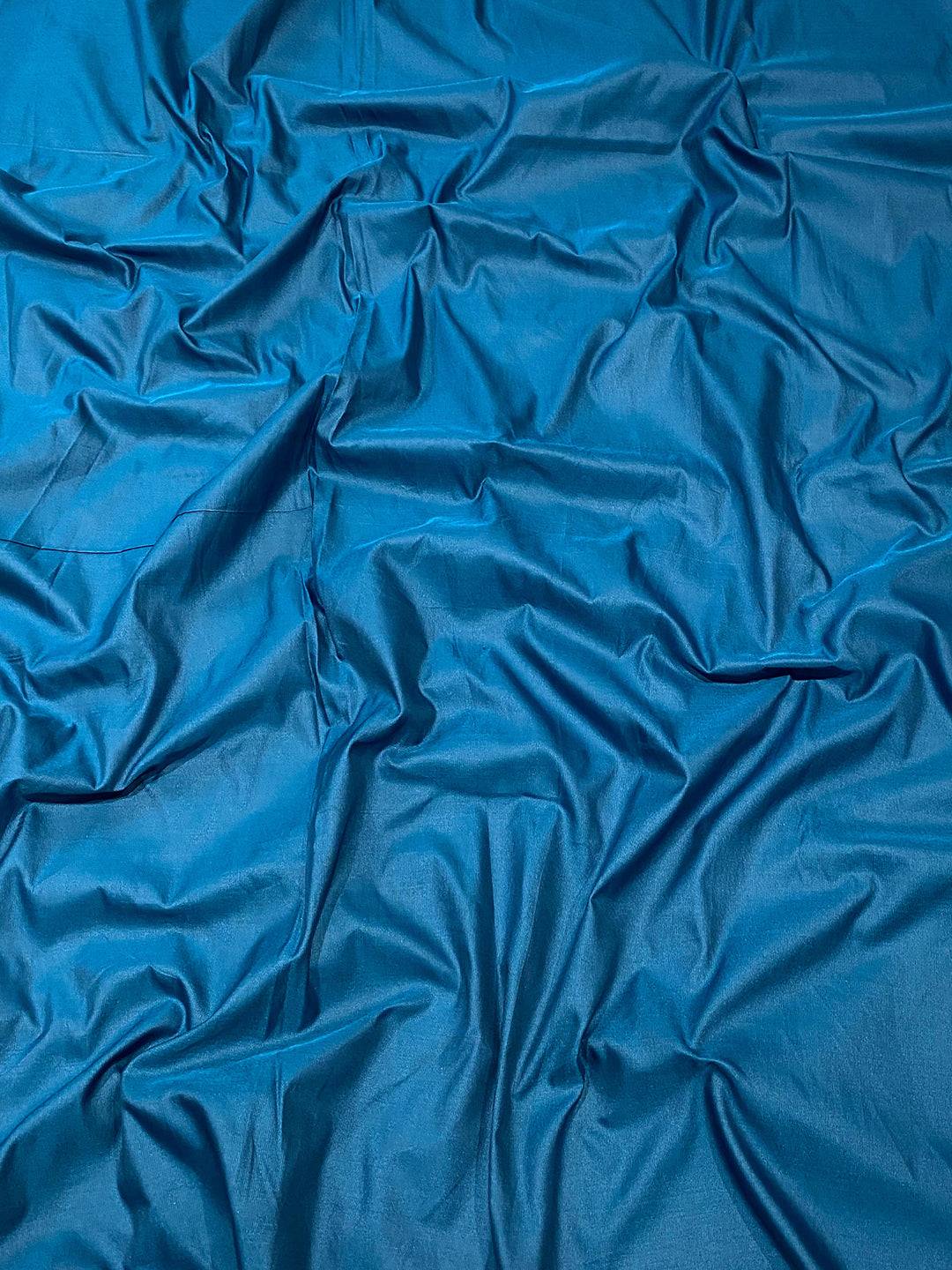 Close-up of Rama soft silk saree fabric texture