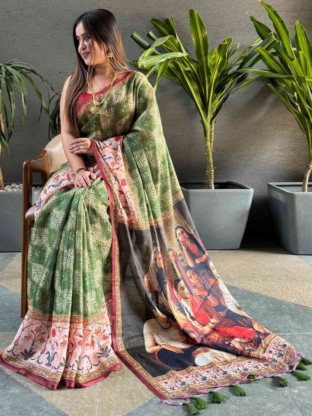 Green saree with kalamkari print, model seated