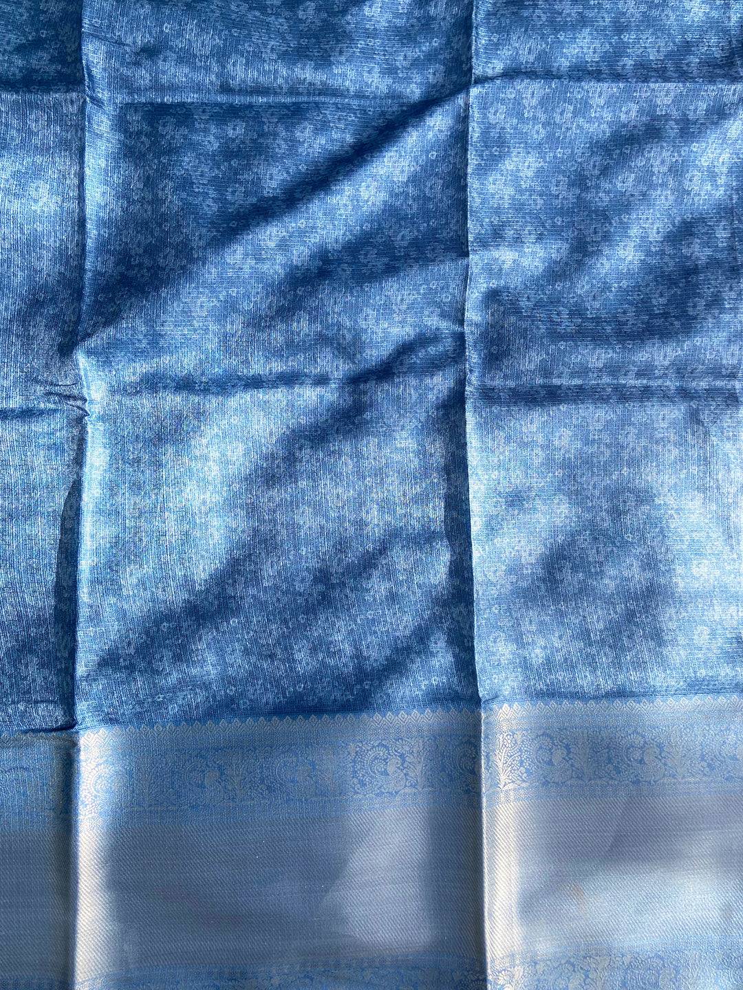 Blue saree fabric with subtle floral patterns
