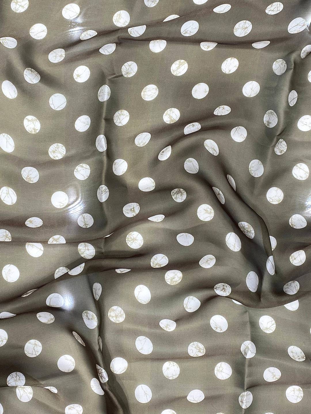 Close-up of polka dot fabric detail on saree
