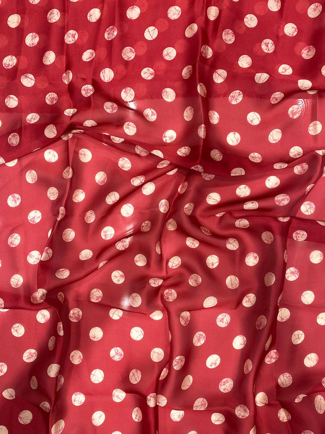 Close-up of red polka dot fabric, textured pattern