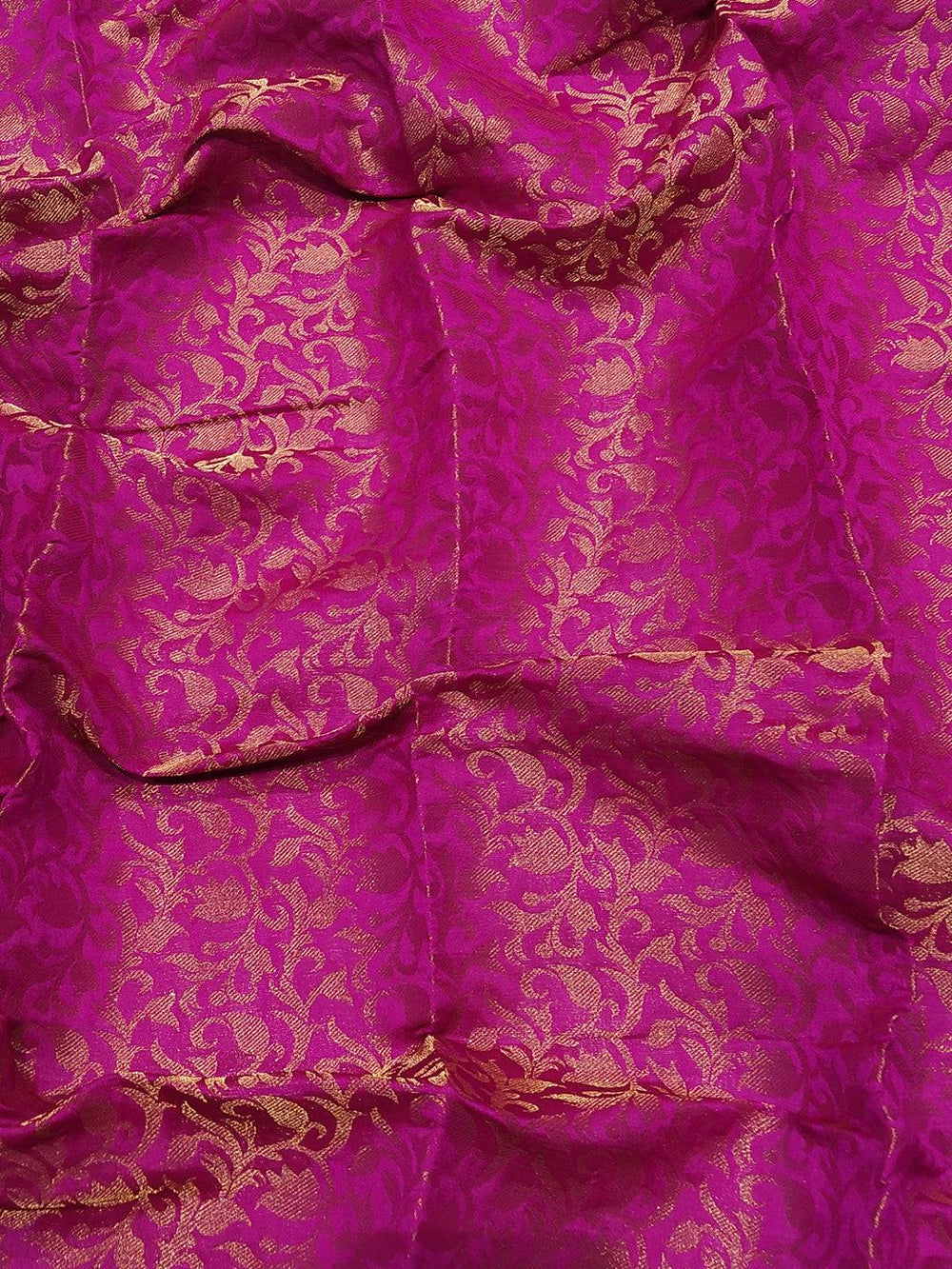 Close-up of pink Kanjivaram weaving on silk fabric
