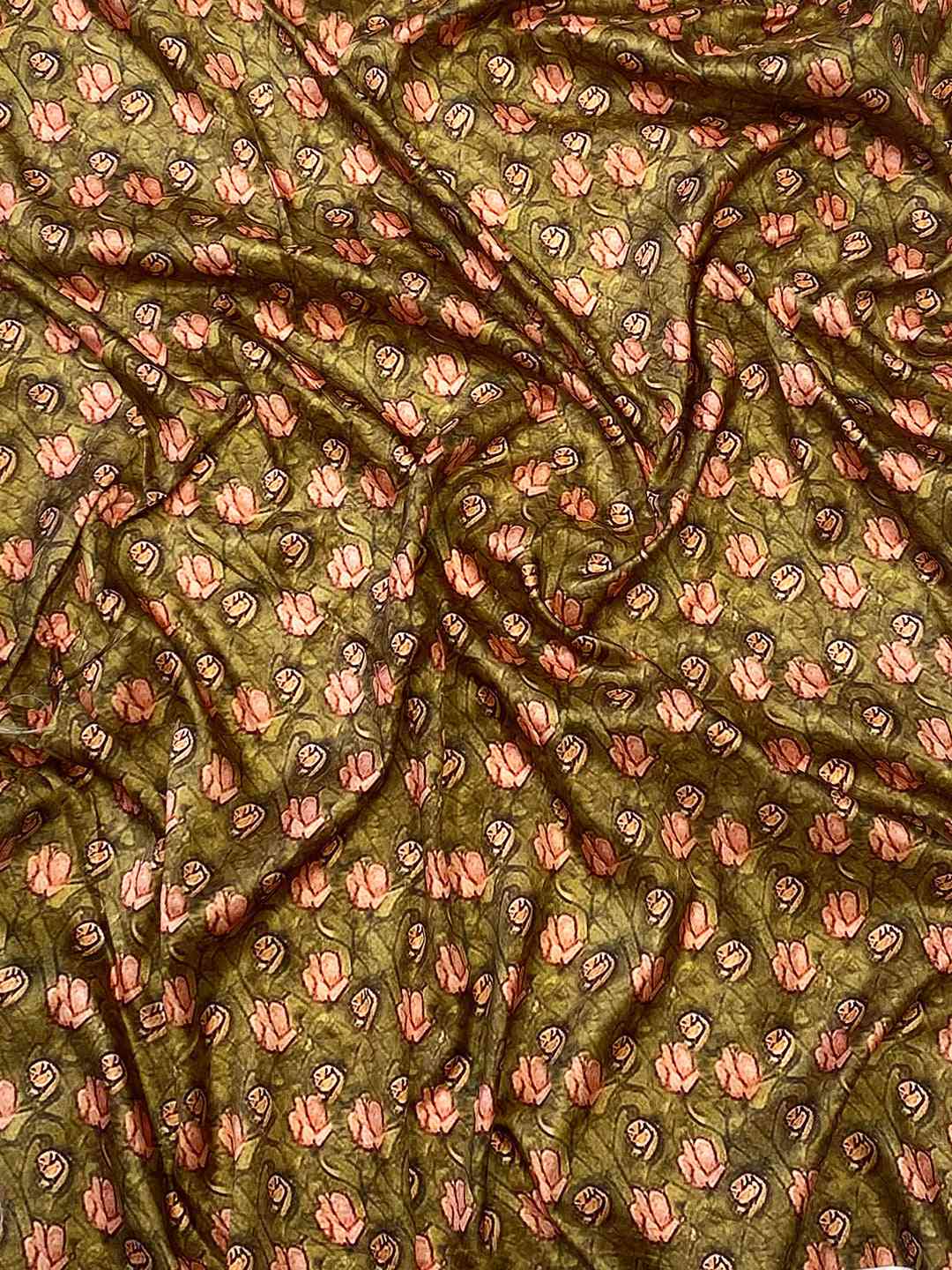 Green fabric with intricate floral Mughal print design
