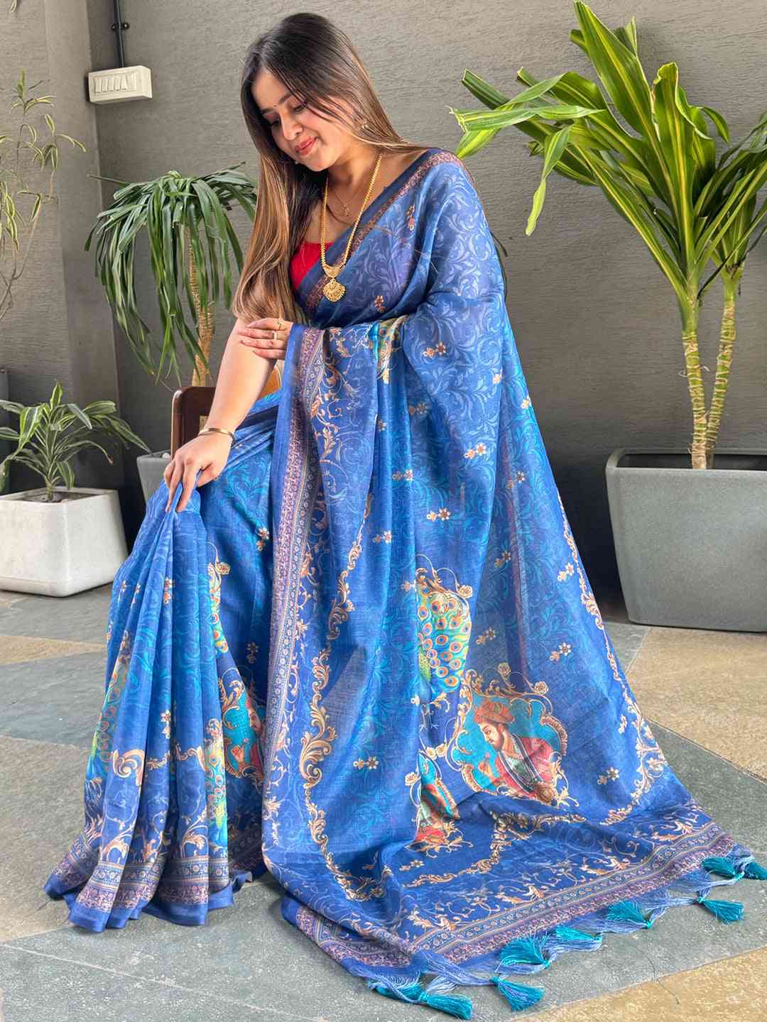 Blue linen saree showcasing digital print and detailed border
