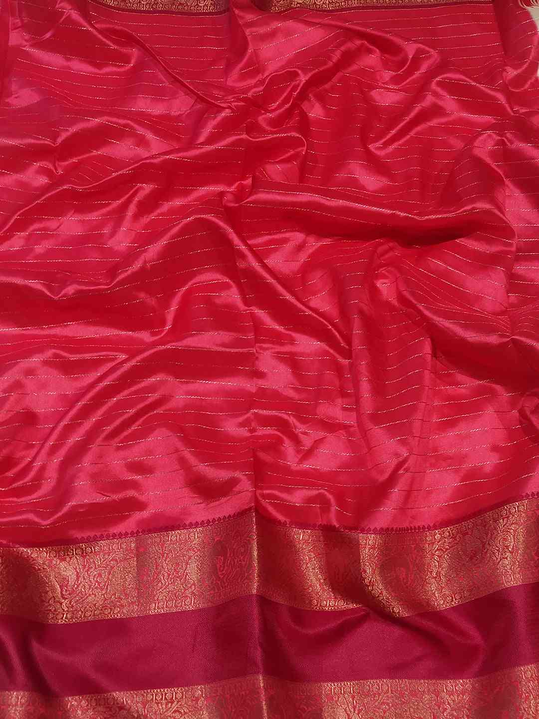 Close-up of red silk fabric with gold detailing
