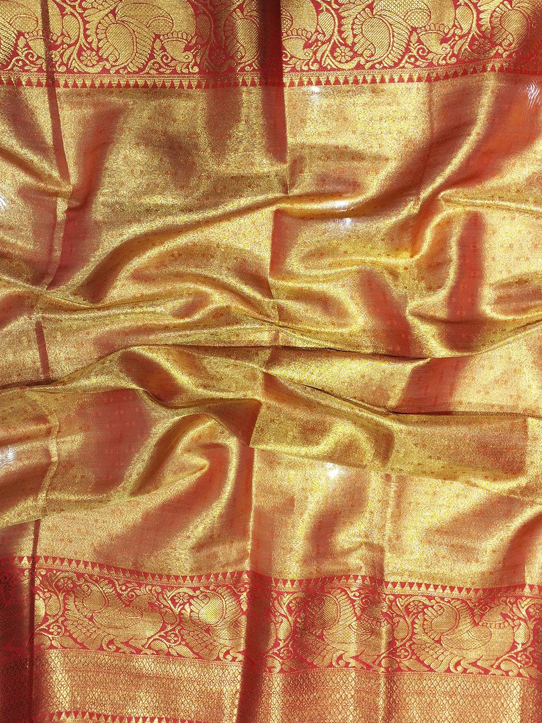 Close-up of red and gold Banarasi silk saree fabric