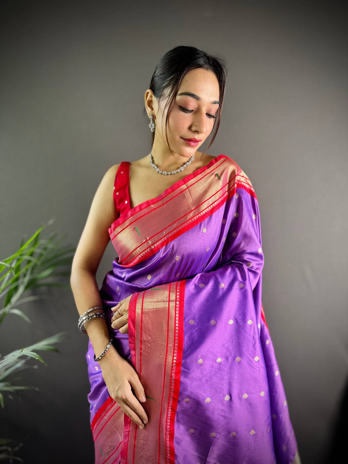 Violet soft silk Paithani saree, close-up of the gold zari pallu and red border draped over the shoulder