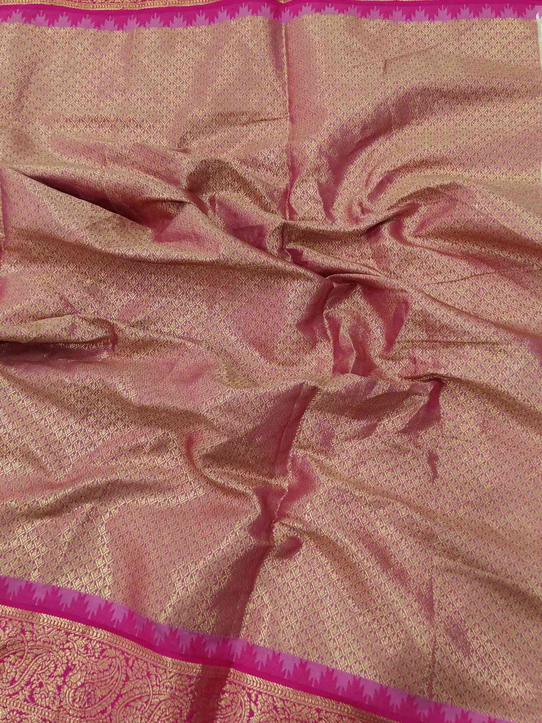 Close-up of Gadwal saree's intricate pink temple border.