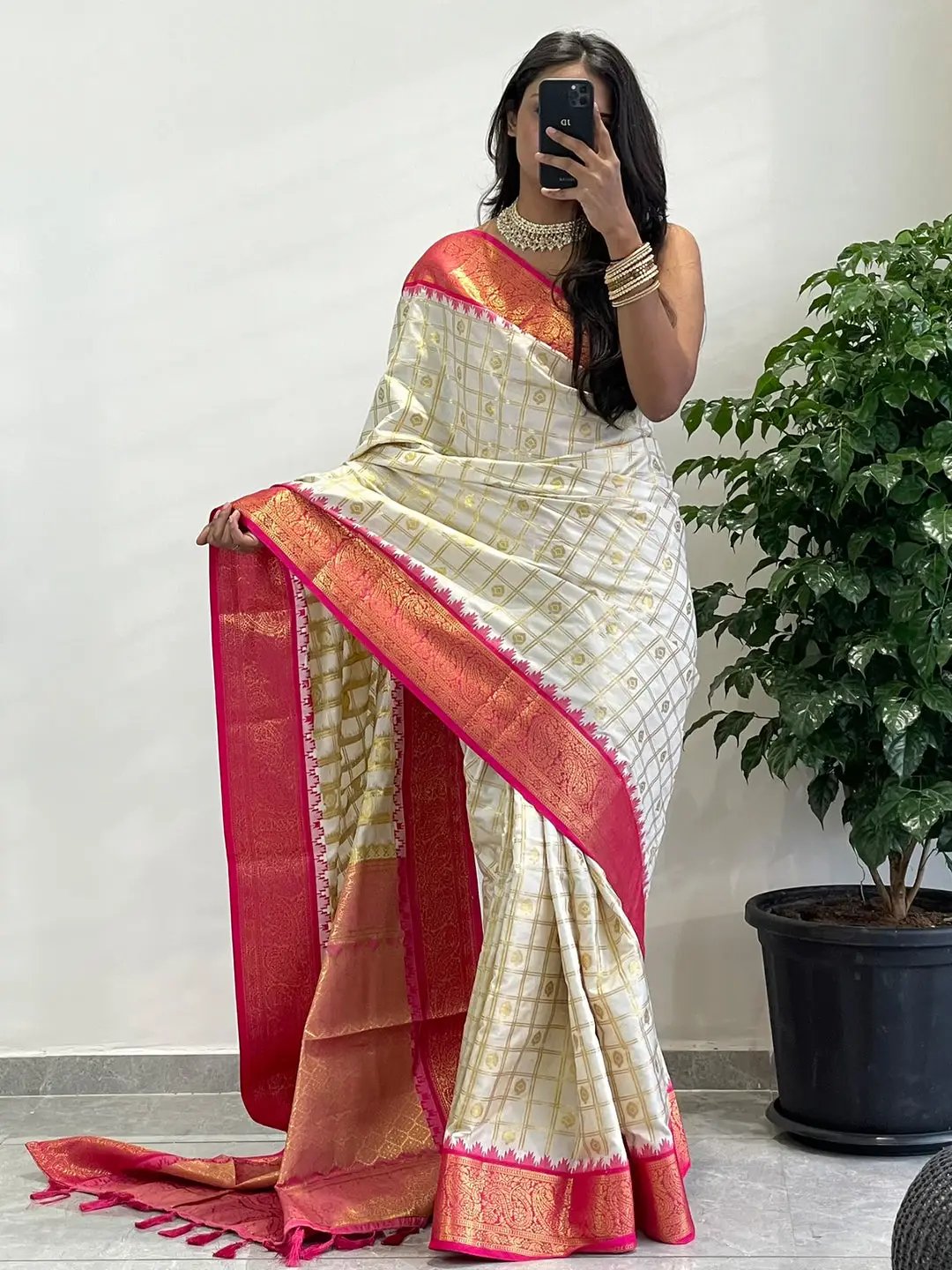 Model showcasing Gadwal saree with vibrant pink temple border.