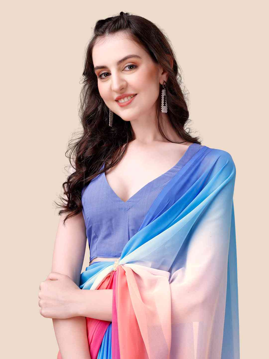 Close-up of woman in ombre saree, showcasing blue to pink gradient.