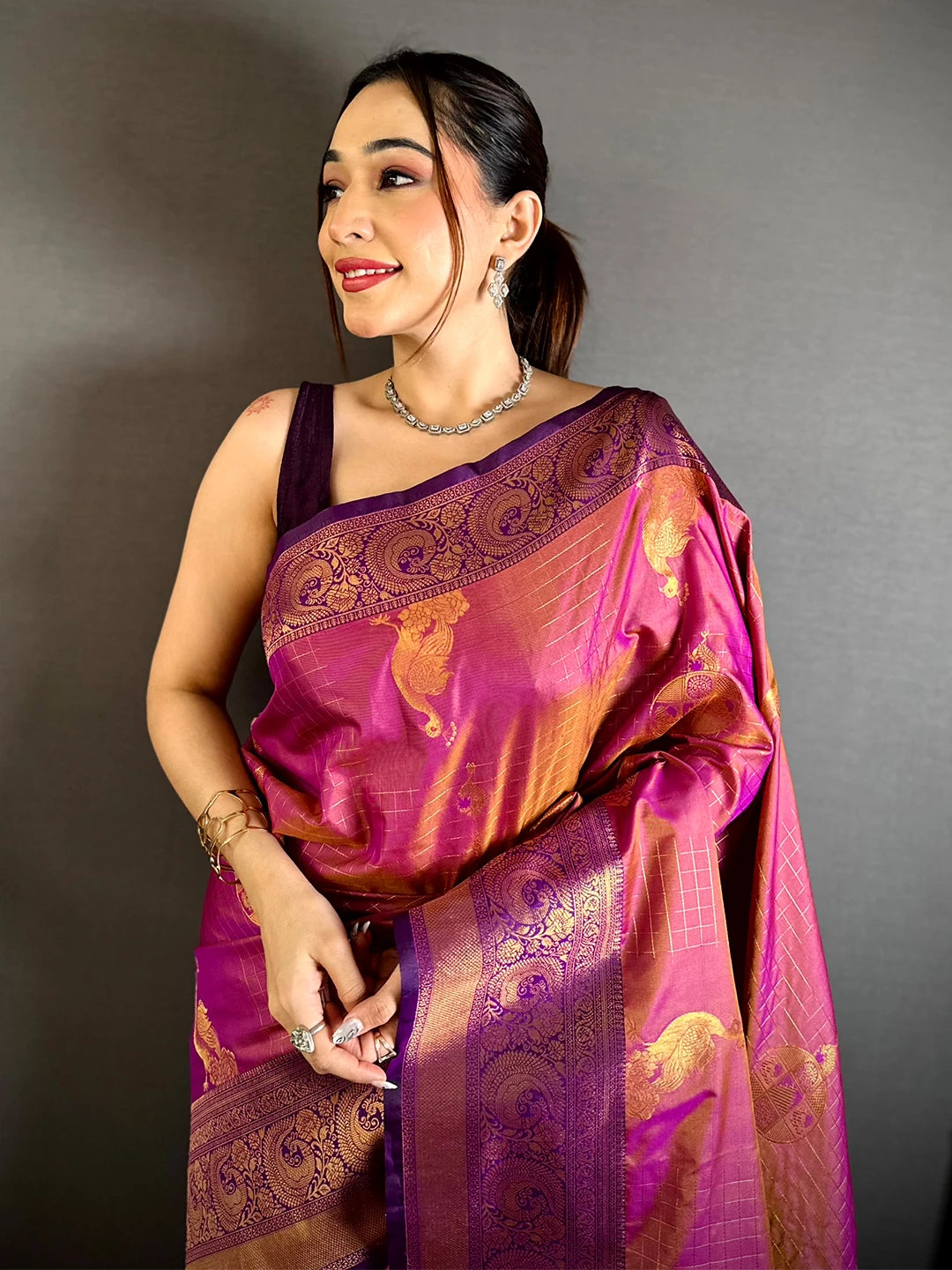 Magenta Soft Silk copper zari weave saree, model front view with checked grid motifs and purple paisley border