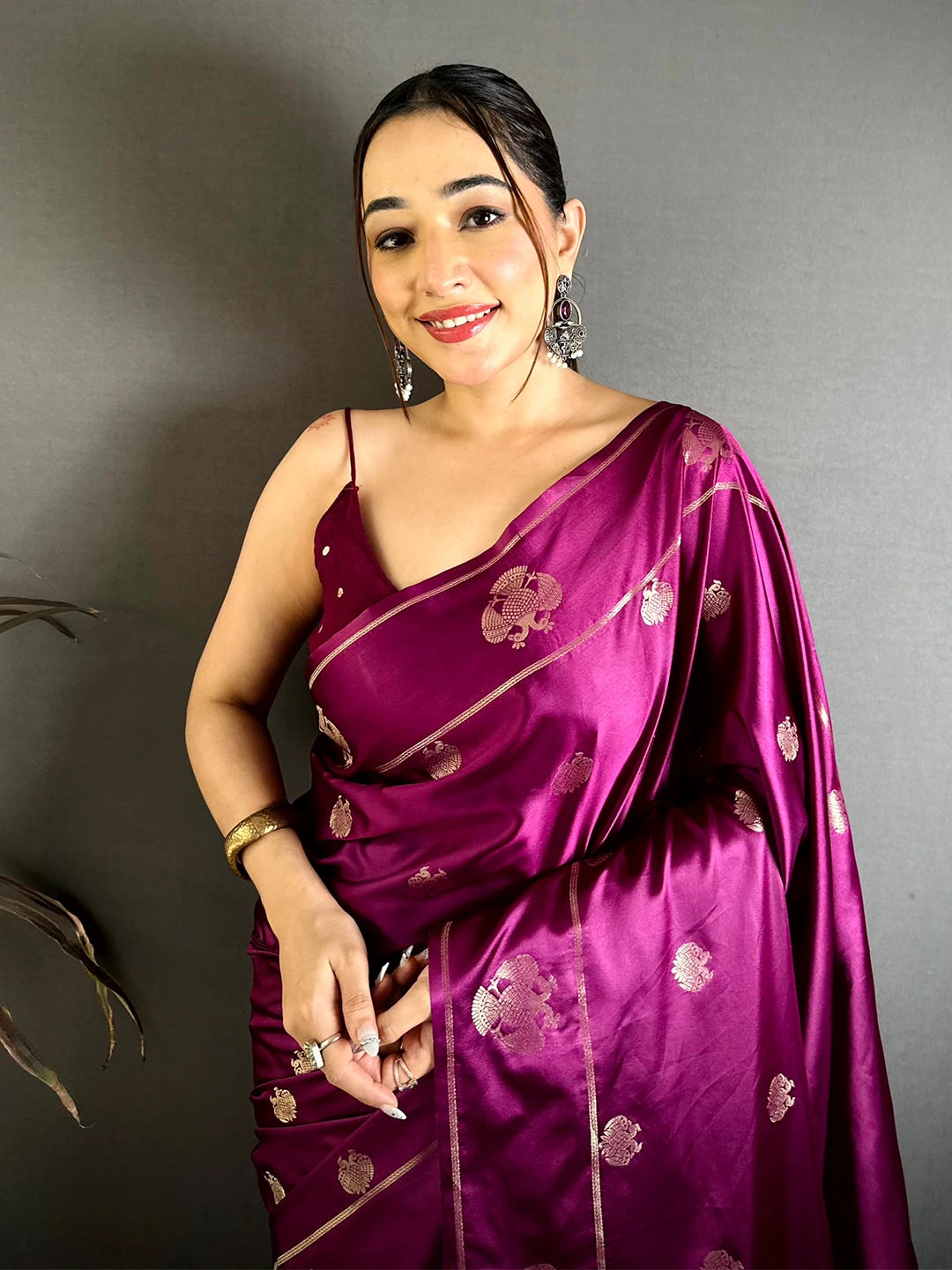 Wine mashru satin silk Garuda zari butta saree, front drape on a model showing the zari motifs and border