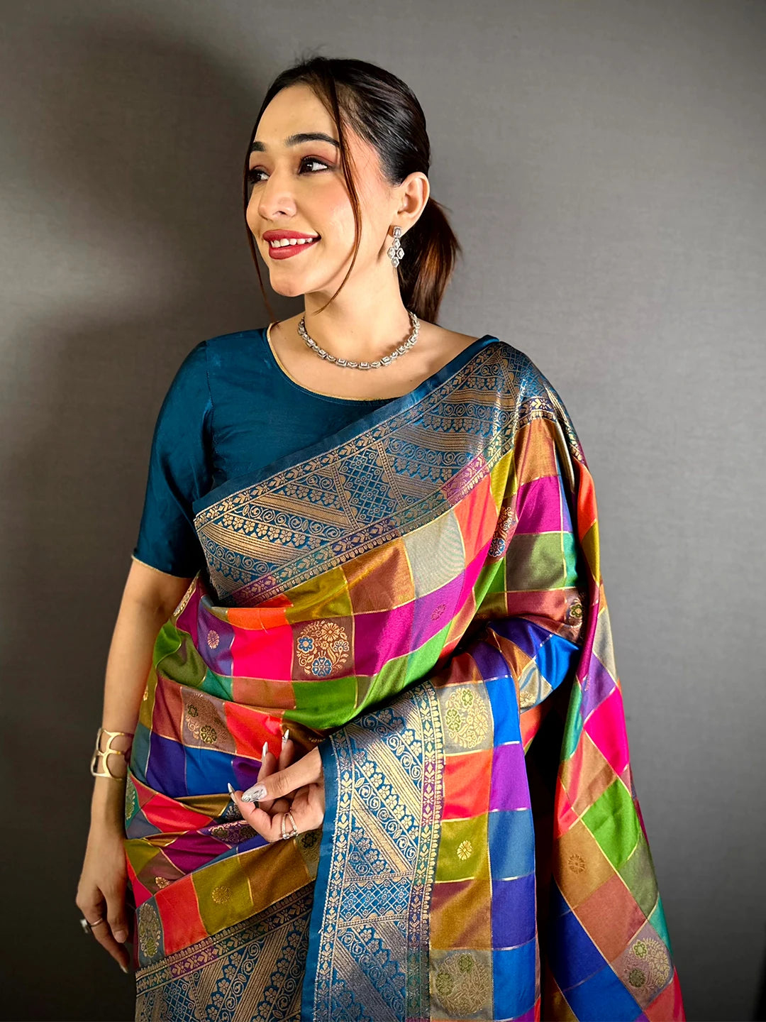 Multicolour silk minakari-style zari butti saree, front drape on model with teal blouse and checked grid