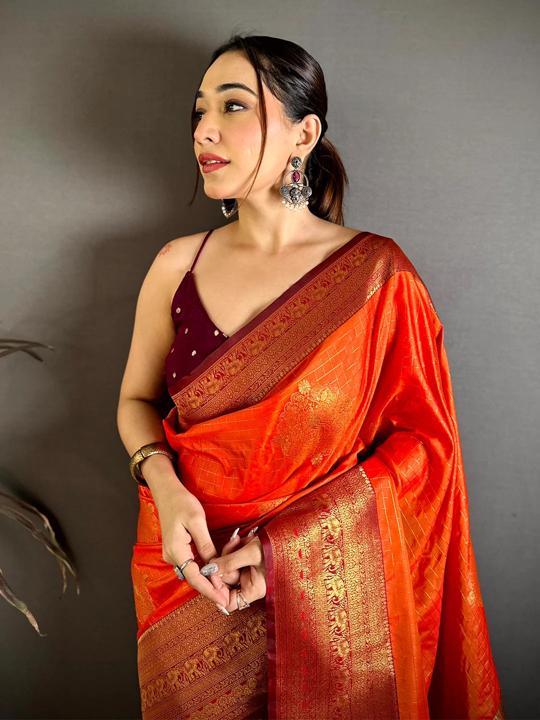 Orange Soft Silk zari check saree, close-up of the maroon zari border and draped pallu worn over the shoulder
