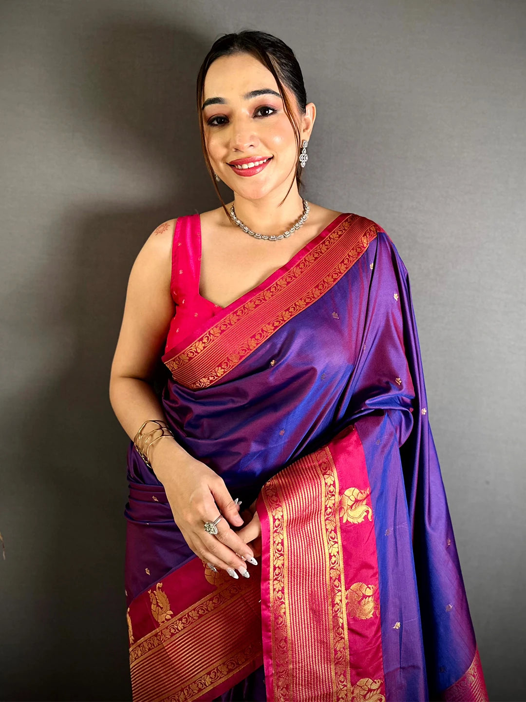 Royal Purple Soft Silk Kanchi Pattu Border Saree, front drape on a smiling model with pink blouse