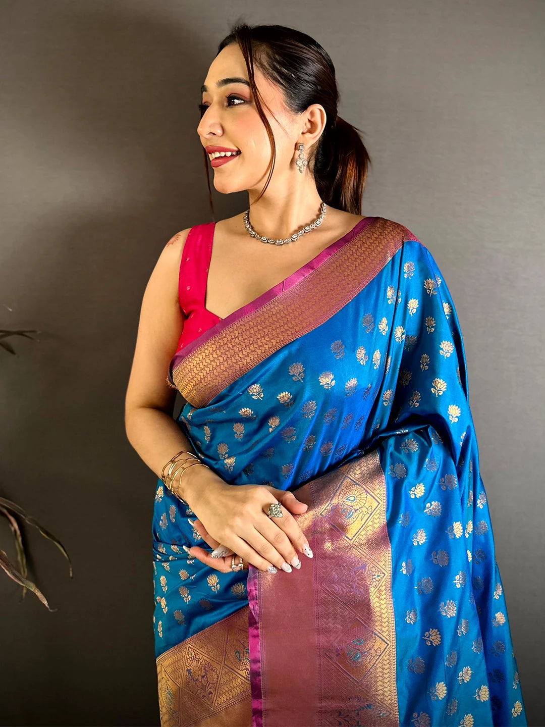 Blue soft silk lotus zari butti saree, model in pink blouse with front drape and copper zari border