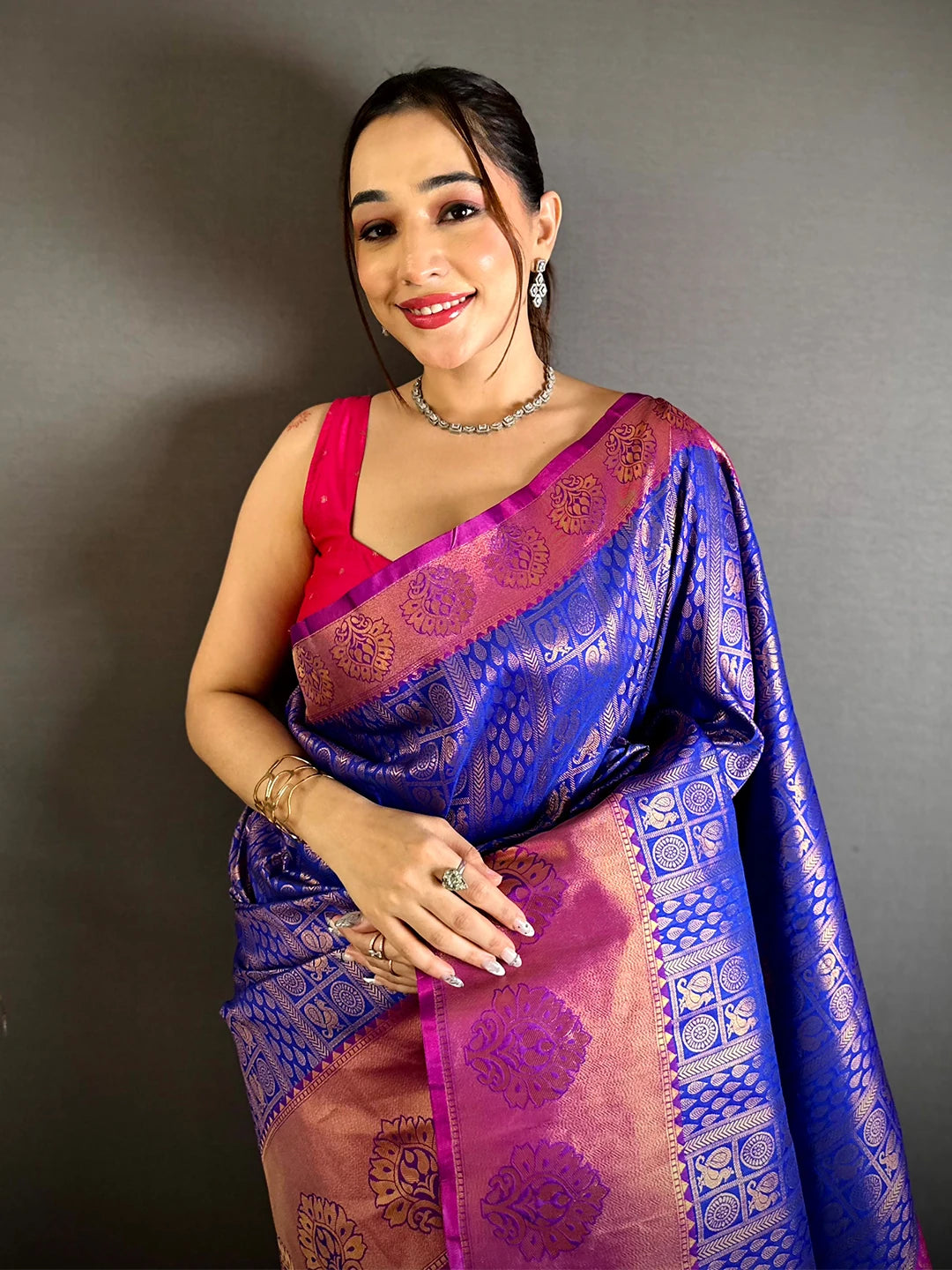 Royal blue soft silk zari woven saree, front drape on a model with pink blouse and magenta kanchi-style border