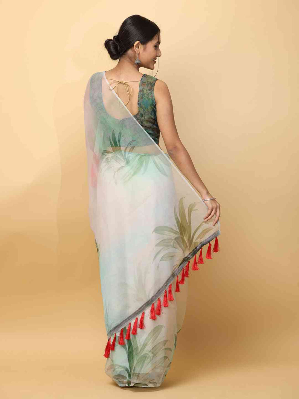 Back view of organza saree with red tassel details