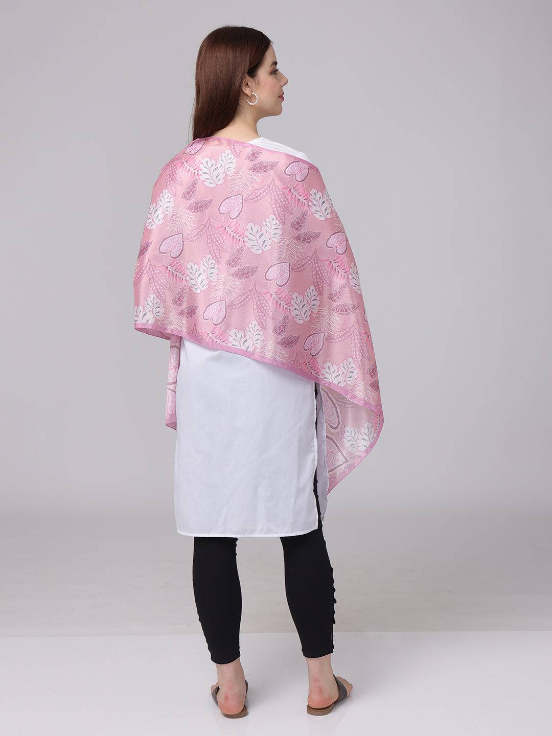 Back view of pink leaf pattern scarf on model.