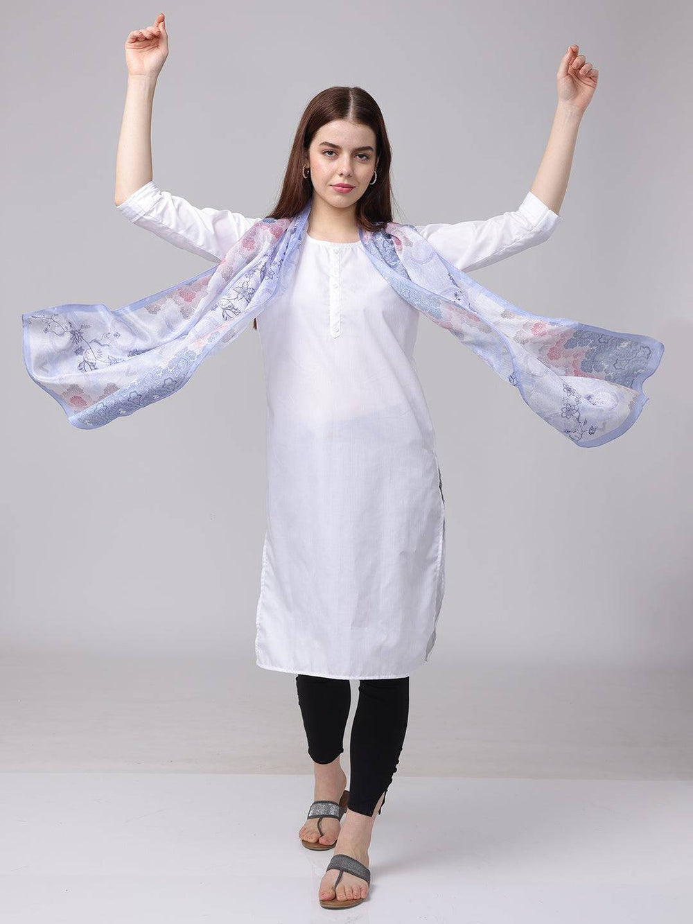 Model showcasing flowing ethnic motifs scarf