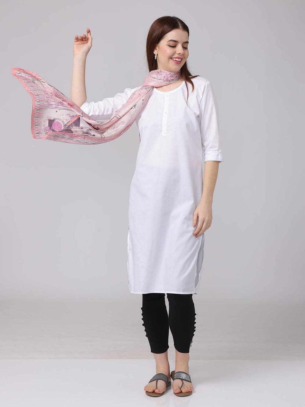 Model posing with abstract printed blossom scarf in soft pastels.