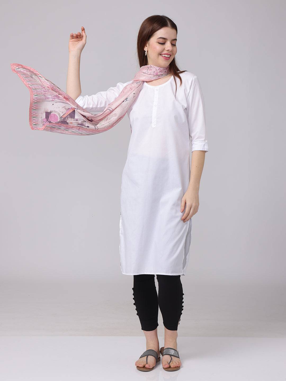 Model posing with abstract printed blossom scarf in soft pastels.