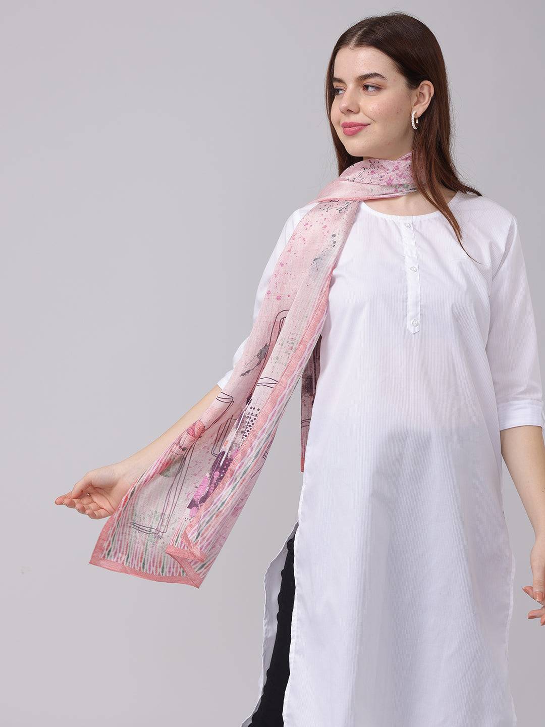 Abstract printed blossom scarf in pastel shades, worn over white tunic.