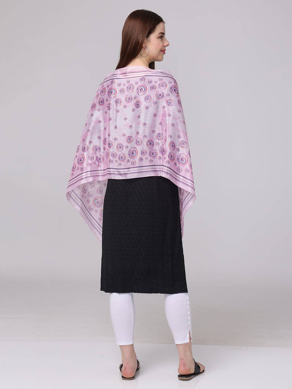 Back view of vibrant circular printed scarf in pink and purple.